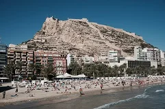 Alicante Airport with Costa Blanca beaches, Mediterranean resorts, palm trees, luxury transfer vehicles, Spanish coastline backdrop, premium airport transportation service