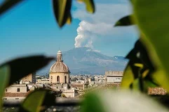 Catania Airport with Mount Etna volcano, baroque architecture, Sicilian coastline, Greek theaters, luxury transfer vehicles, Mediterranean island culture backdrop