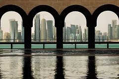 Doha skyline with modern West Bay towers, Museum of Islamic Art geometric architecture, Souq Waqif traditional market, The Pearl-Qatar marina, dhow boats in Arabian Gulf, Corniche waterfront promenade, Katara Cultural Village, desert landscape, Islamic heritage