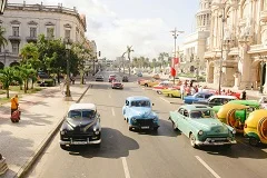 Havana colorful colonial buildings with pastel facades, classic American vintage cars from 1950s, Malecón seawall with ocean waves, Capitol building dome, Revolutionary Square with Che Guevara mural, Cuban musicians playing son music, tobacco fields and cigar rolling, tropical beaches, street life with locals, baroque Spanish architecture
