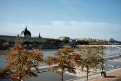 Lyon Airport with French Alps backdrop, modern airport facilities, luxury transfer vehicles, premium airport transportation service to Lyon city and ski resorts