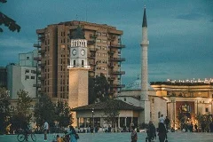 Tirana colorful buildings Skanderbeg Square, Albanian Riviera Ksamil pristine turquoise beaches, Berat white Ottoman houses UNESCO hillside, Gjirokastër stone fortress, Butrint ancient Greek Roman ruins, Blue Eye Spring crystal water, Mediterranean coast cliffs, Albanian cuisine, bunkers, mountains