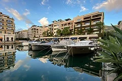 Kotor Bay dramatic fjord with mountains, medieval Kotor fortified walls climbing mountain, Perast waterfront with Our Lady of Rocks island church, Porto Montenegro marina with yachts, serpentine coastal road views, Sveti Stefan pink island resort, Adriatic turquoise waters, Orthodox monastery frescoes, grilled fish