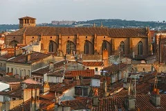 Toulouse Airport with Pyrenees mountains backdrop, pink city architecture, luxury transfer vehicles, premium airport transportation service to Toulouse and Pyrenees ski resorts
