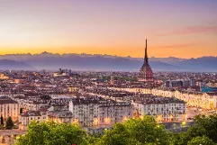 Turin Caselle Airport transfer service showcasing luxury vehicles ready to transport passengers from Turin Airport to Italian Alps ski resorts, elegant city of Turin with Mole Antonelliana landmark, premium Italian alpine transportation