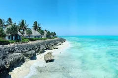Zanzibar pristine beaches with turquoise waters, traditional dhow boats, Stone Town historical architecture, spice plantations, palm trees, white sand beaches, coral reefs, Swahili culture