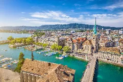 Zurich Airport in Swiss Alps with snow-capped mountains, luxury ski transfer vehicles, traditional Swiss alpine architecture, premium ski resort transportation service