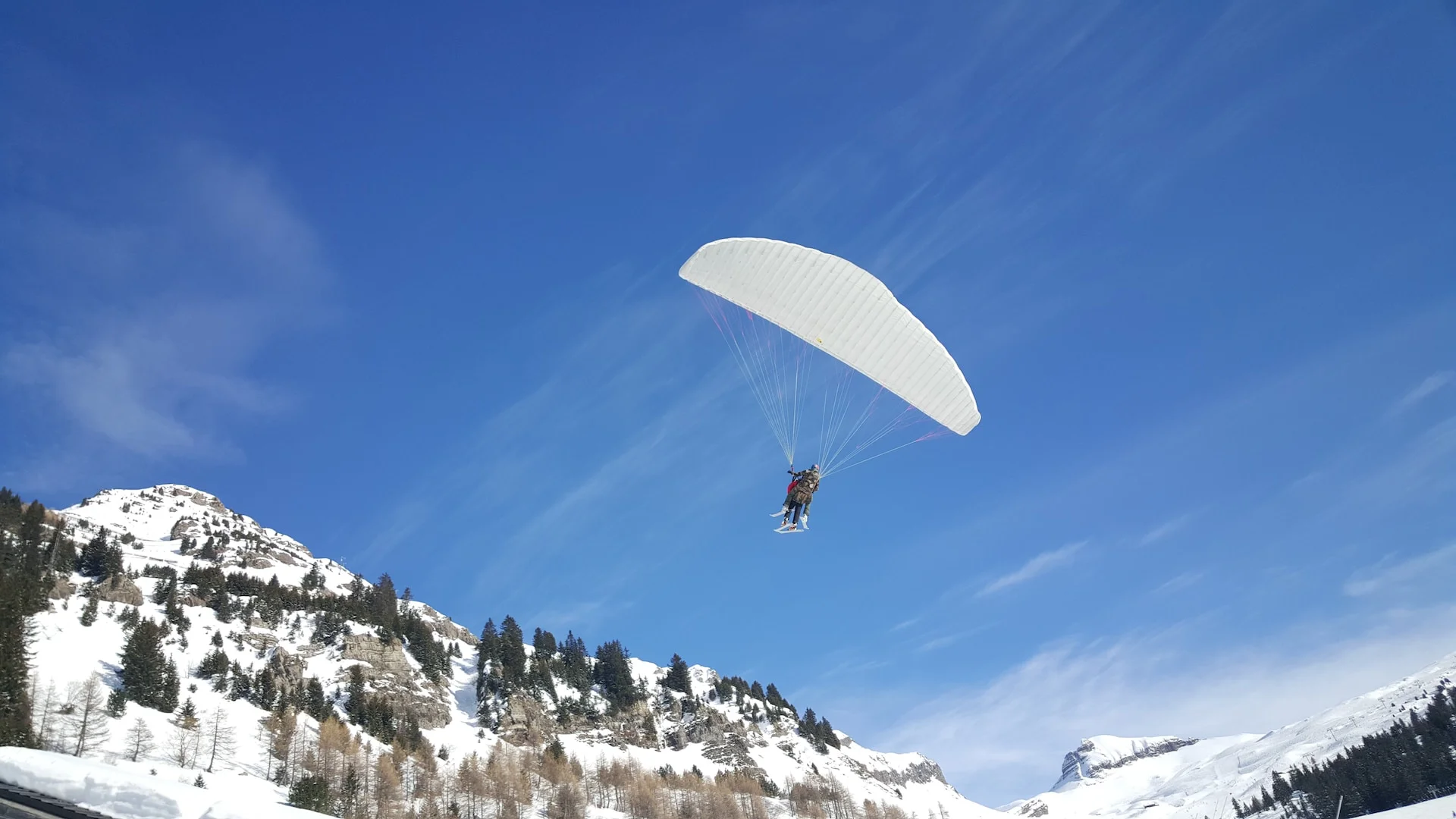 person using parachute near mountain