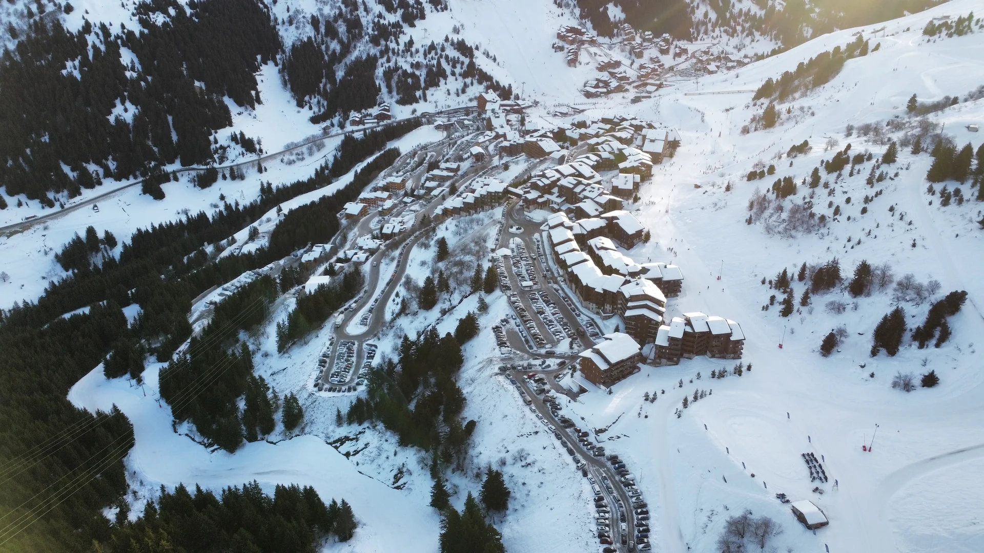 an aerial view of a ski resort in the mountains