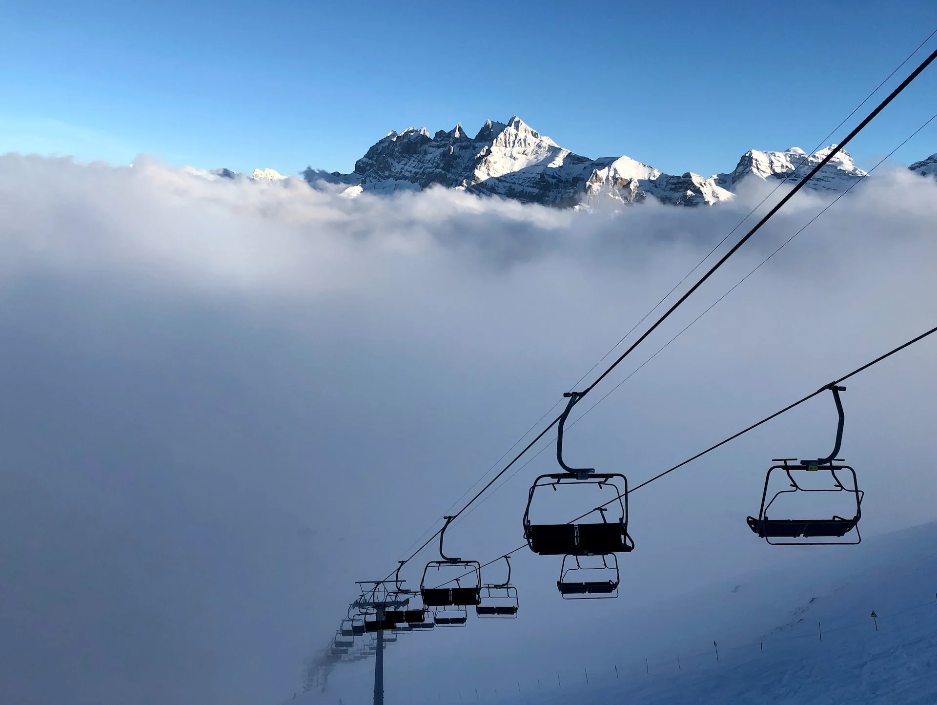 aerial photography of cable cars in a snowy mountain